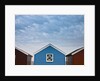 Beach huts in a row against sky by Assaf Frank